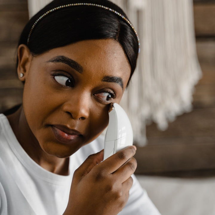 Woman using an at-home facial toning device